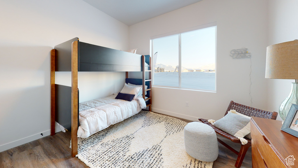 Bedroom featuring wood finished floors and baseboards