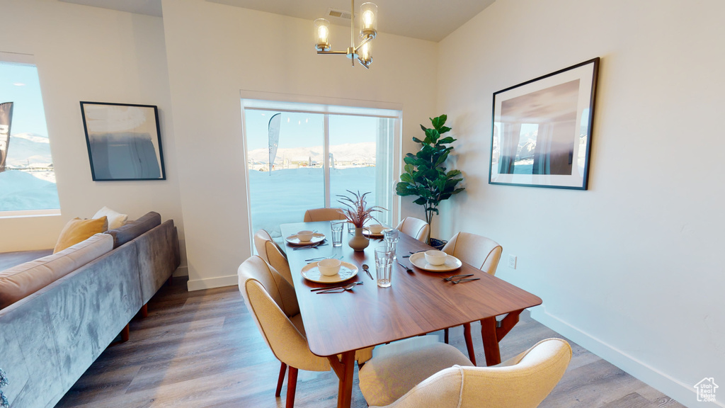 Dining area featuring wood finished floors and a chandelier