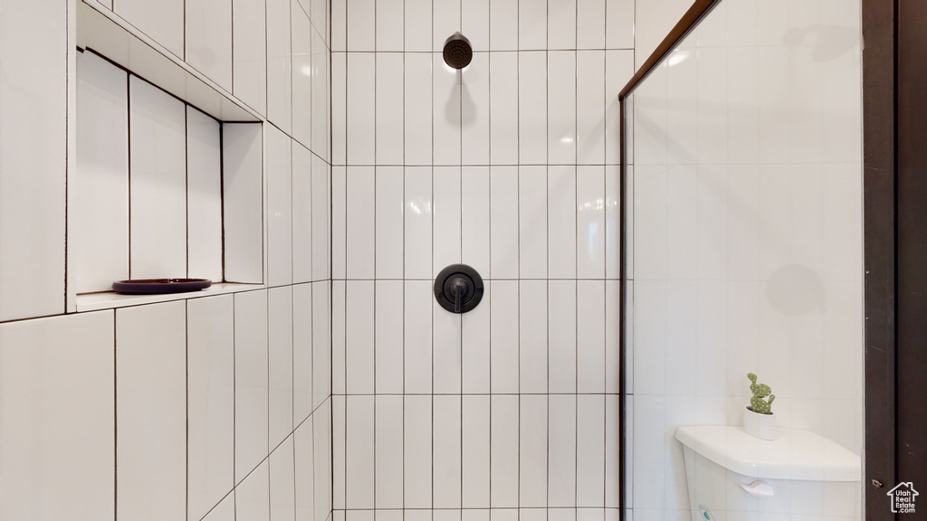 Bathroom with a tile shower and toilet