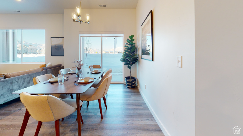 Dining area with a chandelier and wood finished floors