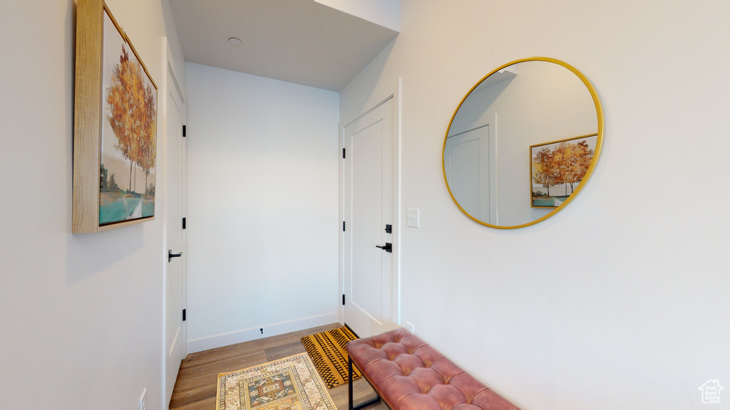 Hallway with wood finished floors and baseboards