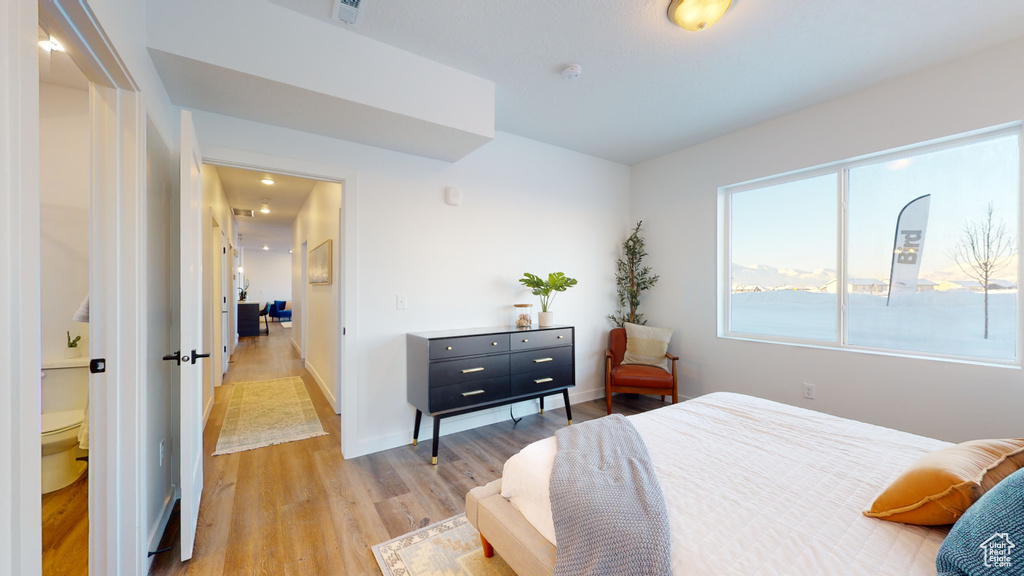 Bedroom with light wood-type flooring and baseboards