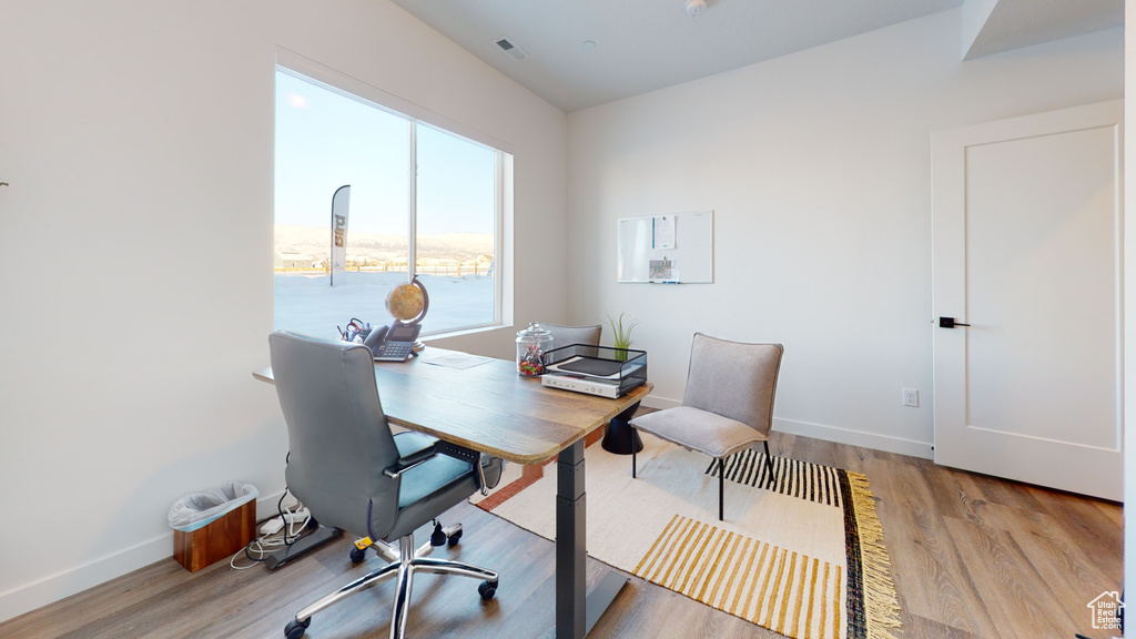 Home office with light wood-style flooring