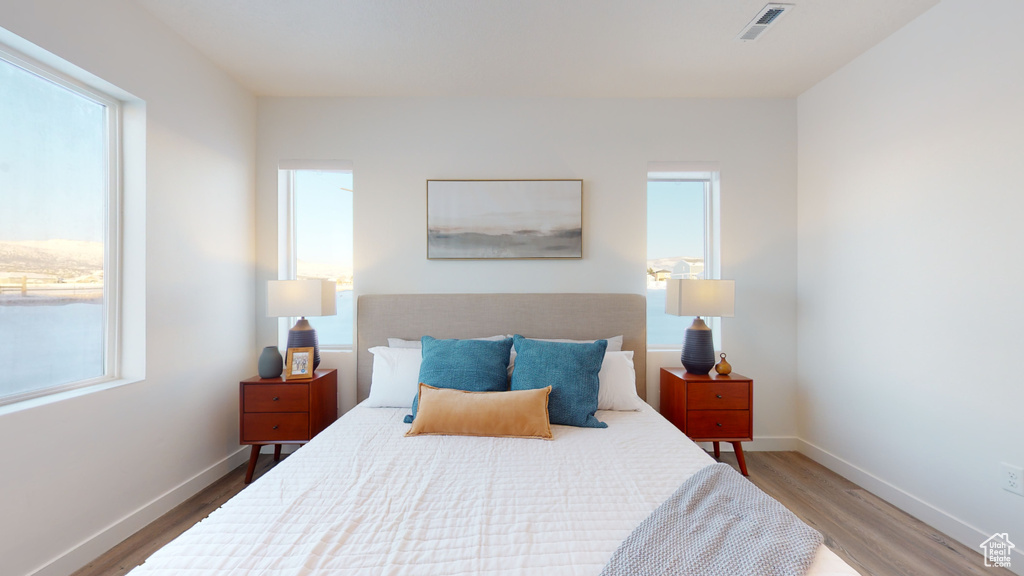 Bedroom featuring wood finished floors and baseboards