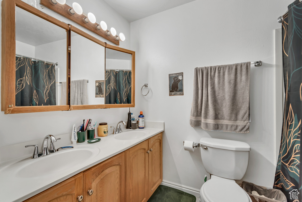 Bathroom featuring double vanity and a shower with curtain