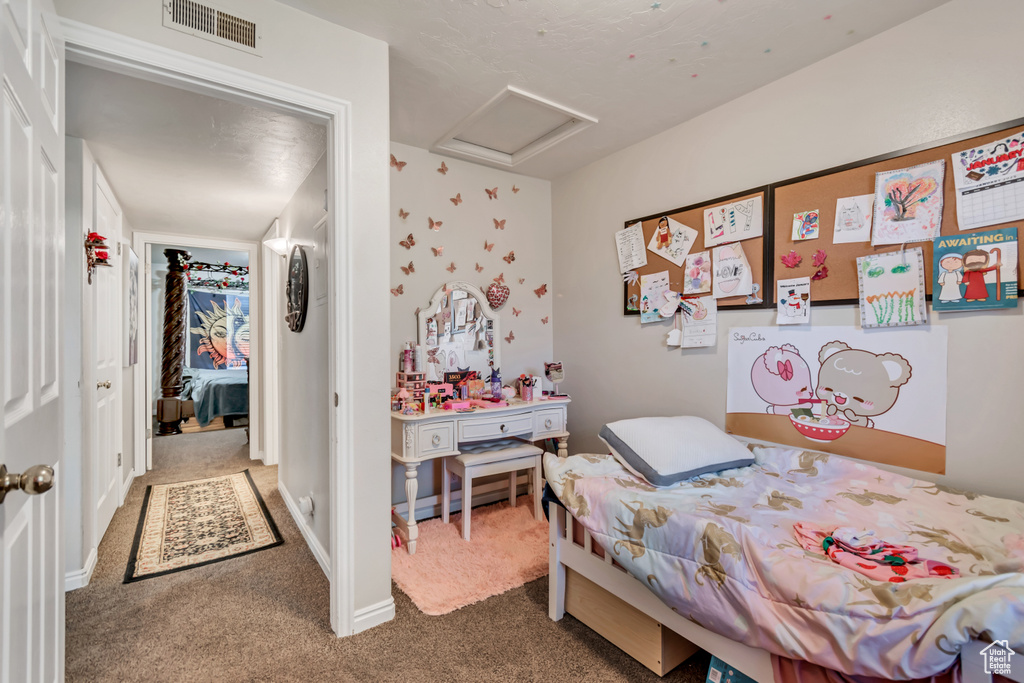 Carpeted bedroom with attic access