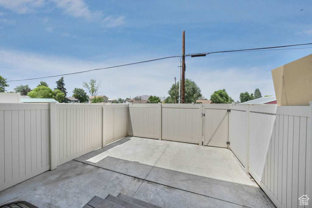 Fenced backyard with a gate and a patio area