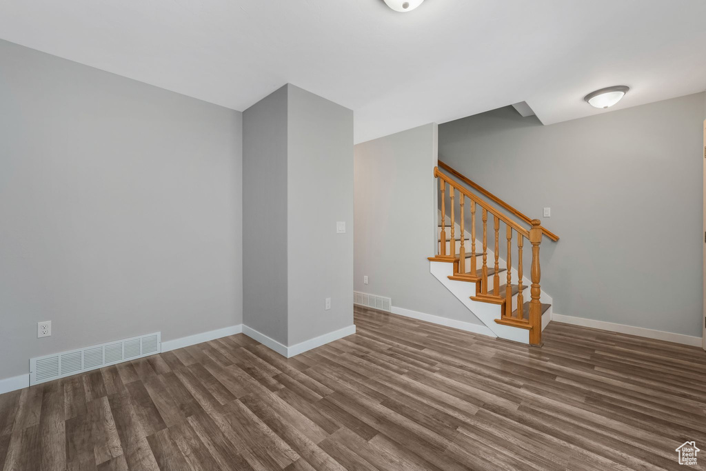 Empty room featuring wood finished floors and stairs