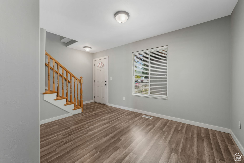 Entryway featuring wood finished floors and stairs
