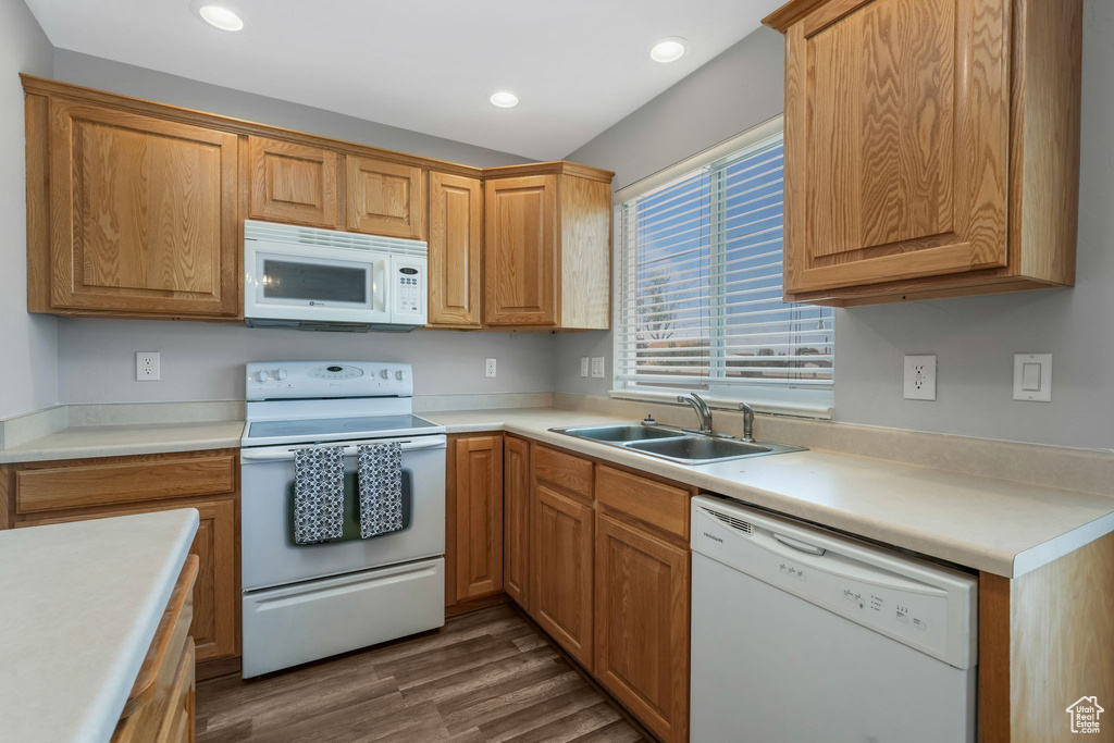 Kitchen with white appliances, dark wood-type flooring, recessed lighting, and light countertops