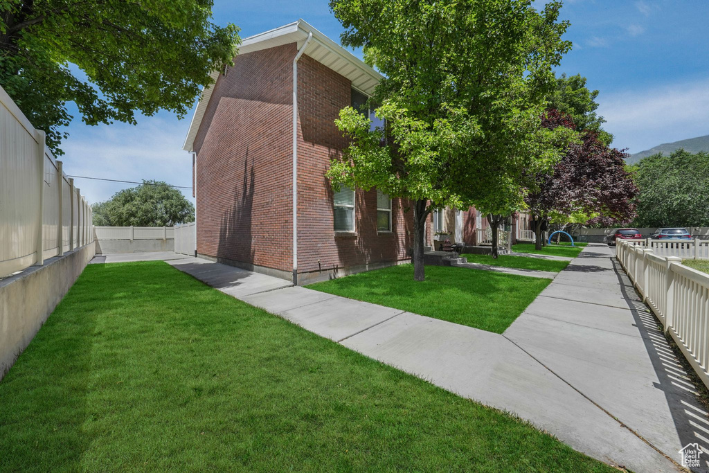 View of property exterior with brick siding