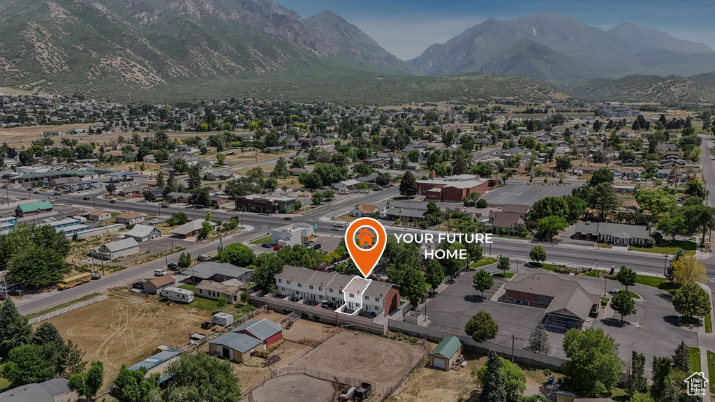 Aerial overview of property's location featuring a mountainous background