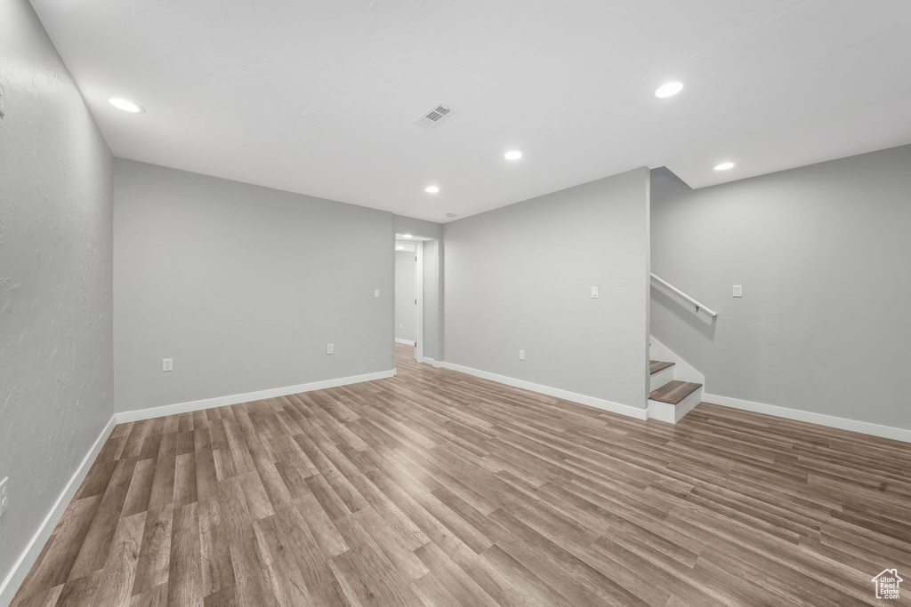 Spare room featuring stairs, light wood-style flooring, and recessed lighting