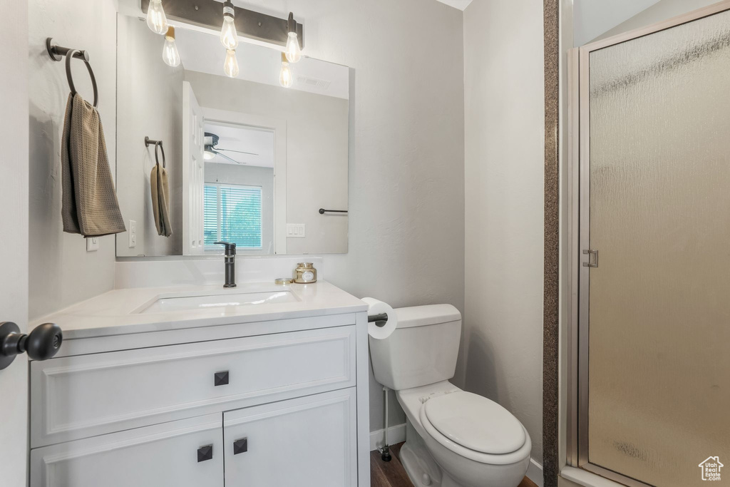 Bathroom with a stall shower, vanity, and a ceiling fan