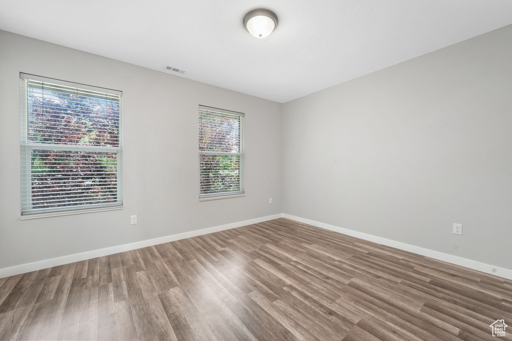 Empty room featuring wood finished floors and baseboards