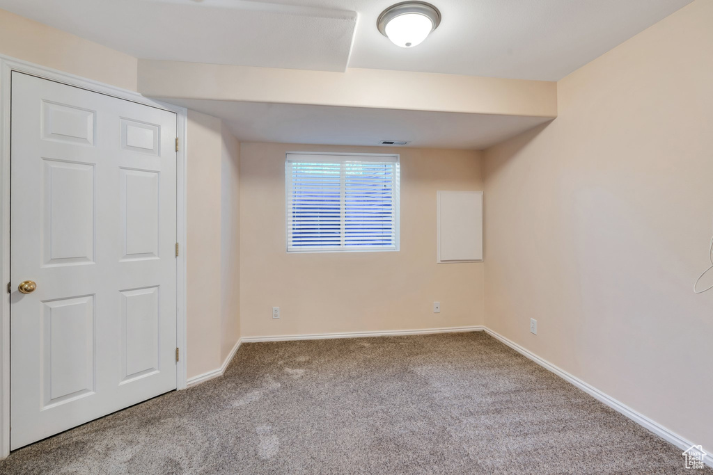 Unfurnished bedroom with carpet floors and baseboards