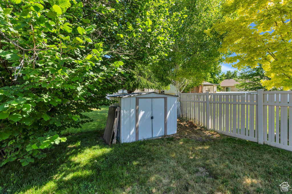 Fenced backyard with a storage shed