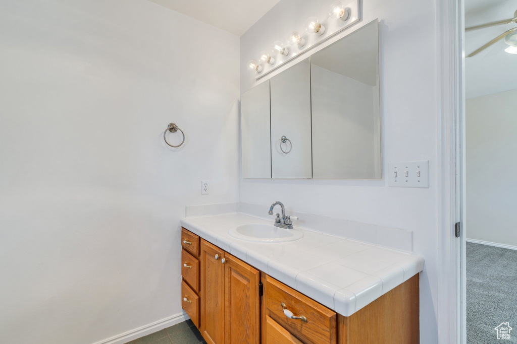 Bathroom featuring vanity and a ceiling fan