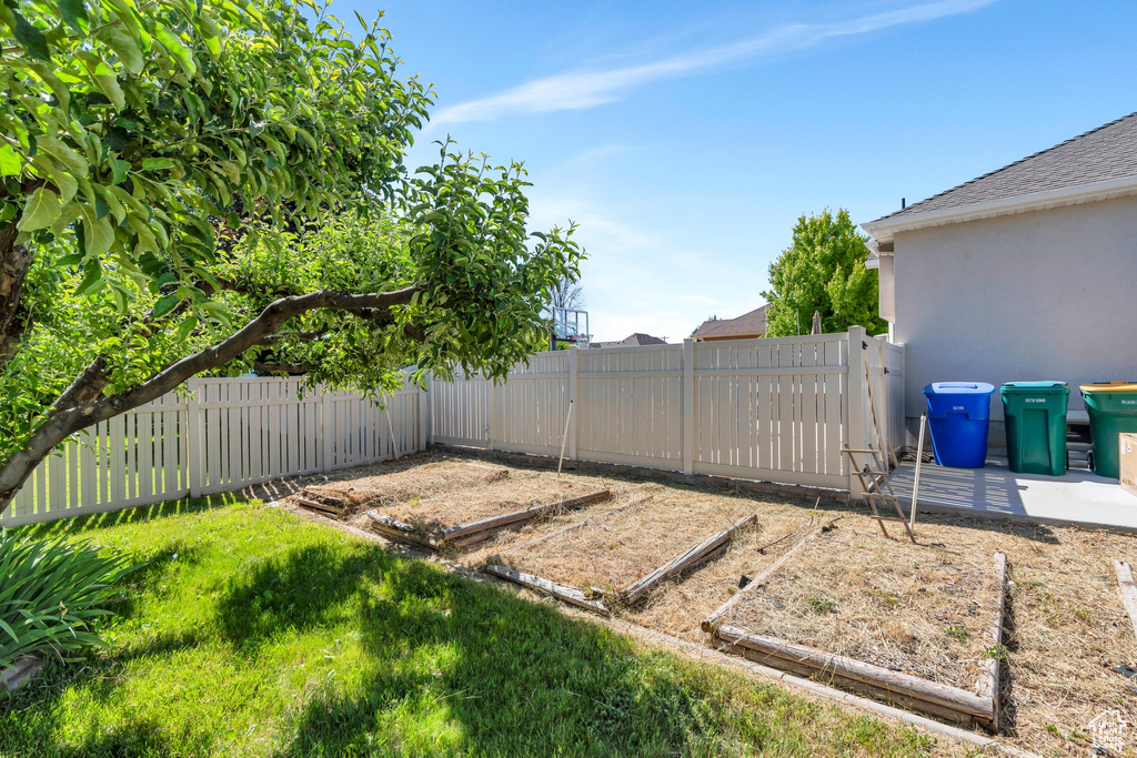 Fenced backyard with a garden