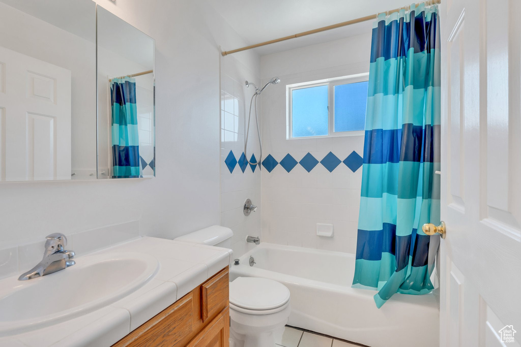 Bathroom featuring shower / bath combo and vanity