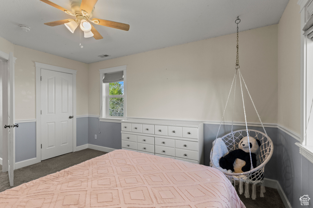 Bedroom featuring dark colored carpet and ceiling fan