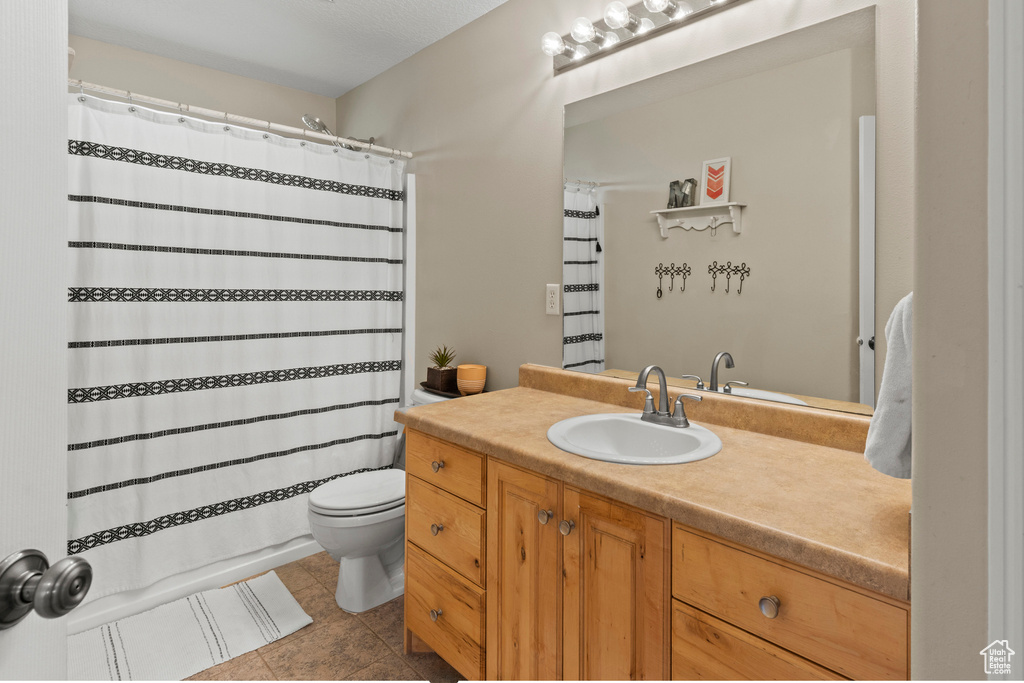 Full bathroom featuring tile patterned flooring and vanity