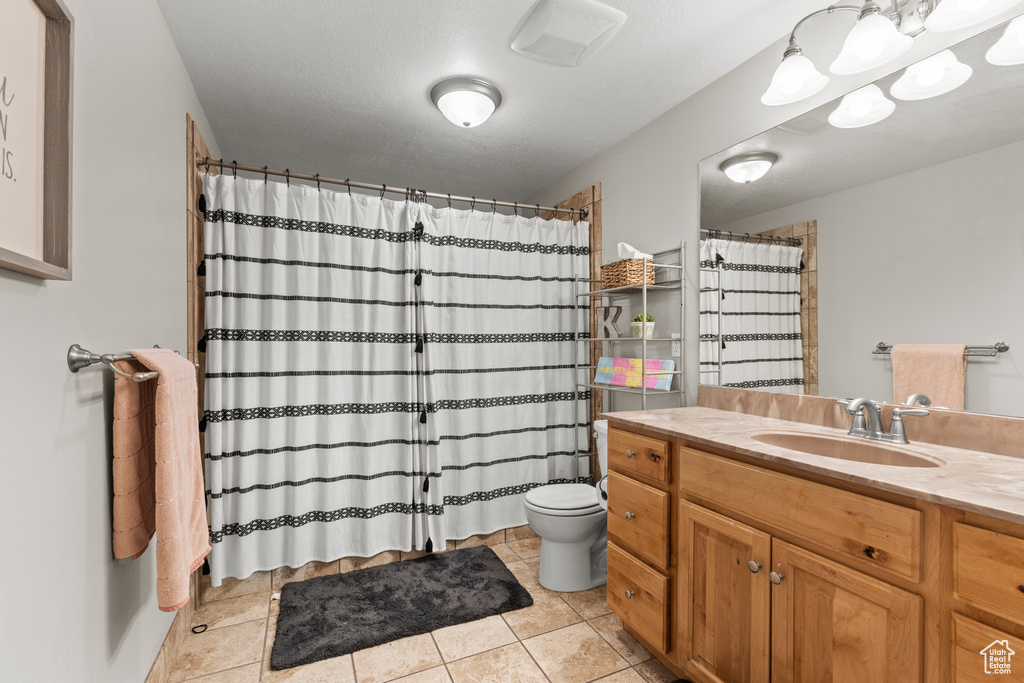 Full bathroom featuring vanity, tile patterned flooring, and a shower with shower curtain