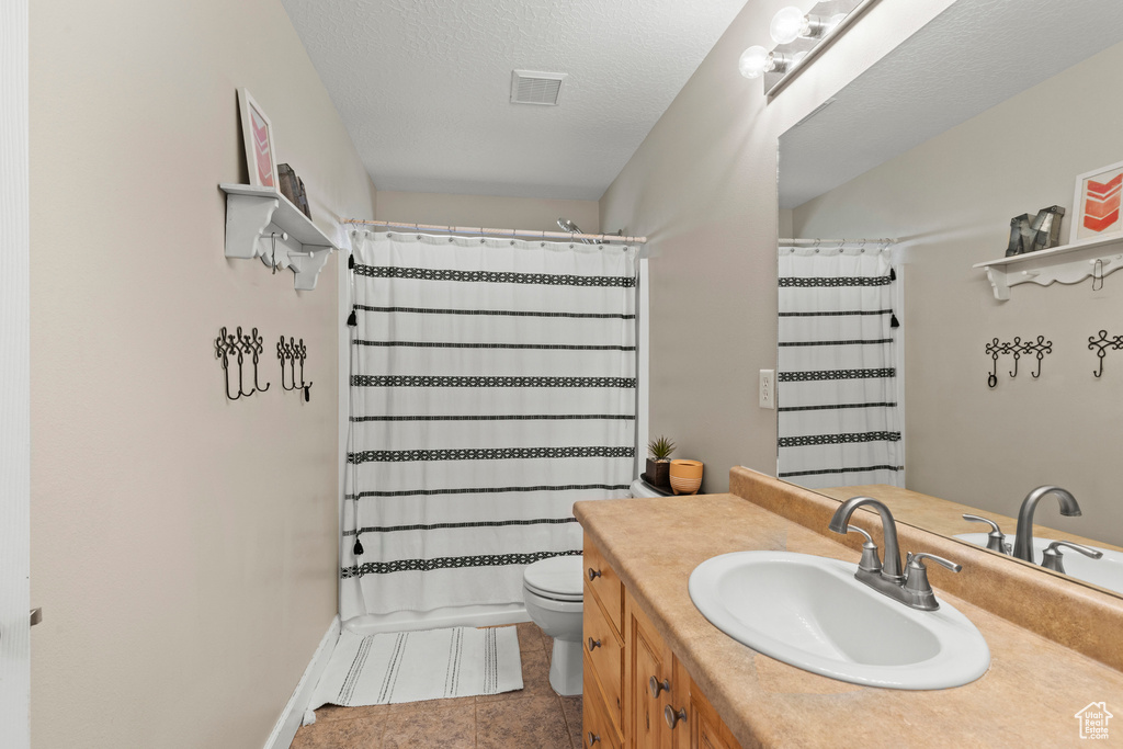 Bathroom with vanity and tile patterned flooring