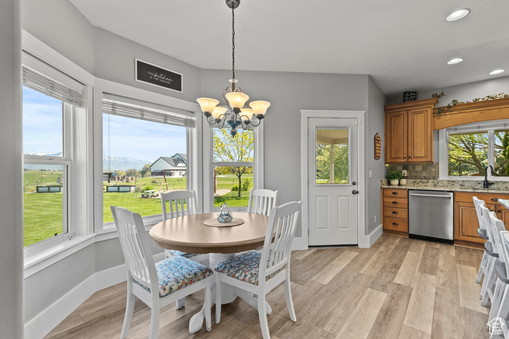 Dining room featuring light wood-style floors, a chandelier, and recessed lighting