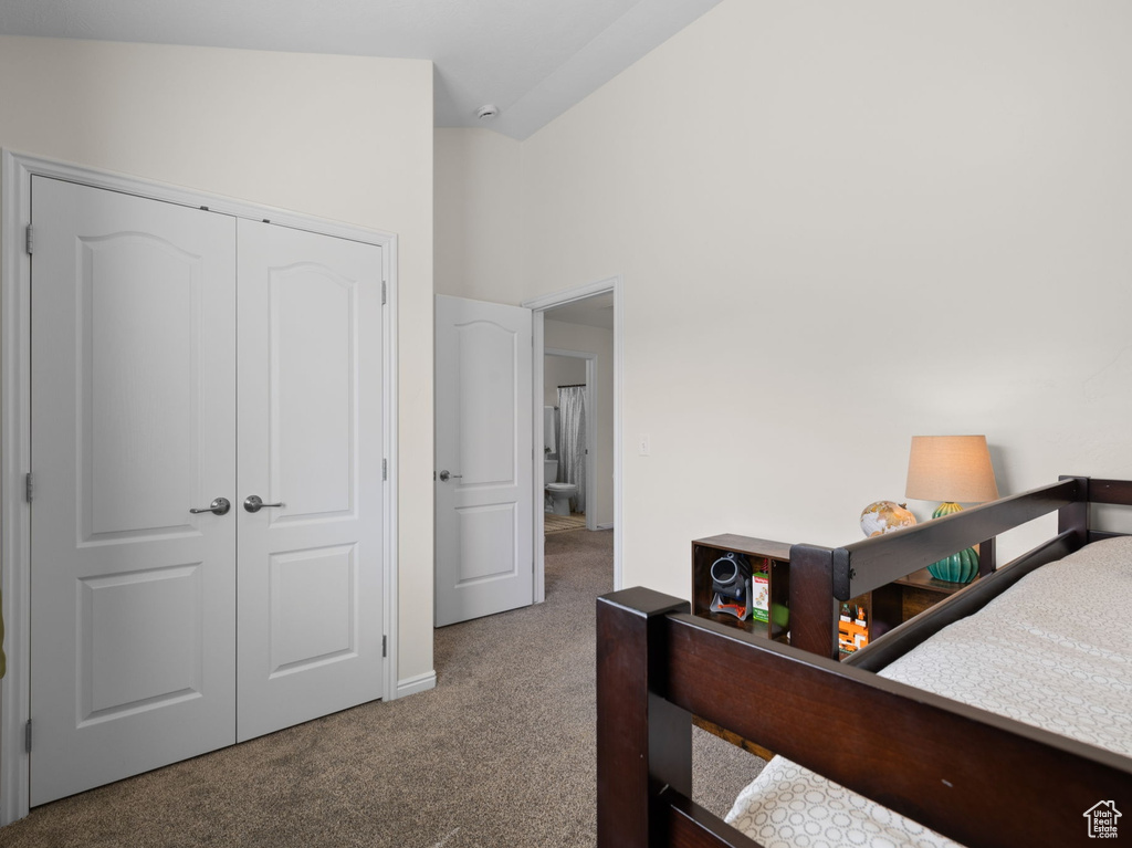 Carpeted bedroom featuring a closet and baseboards