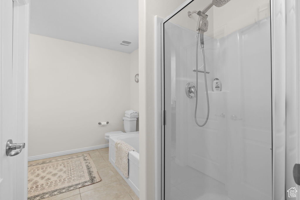Full bathroom featuring a shower stall, tile patterned flooring, and a garden tub