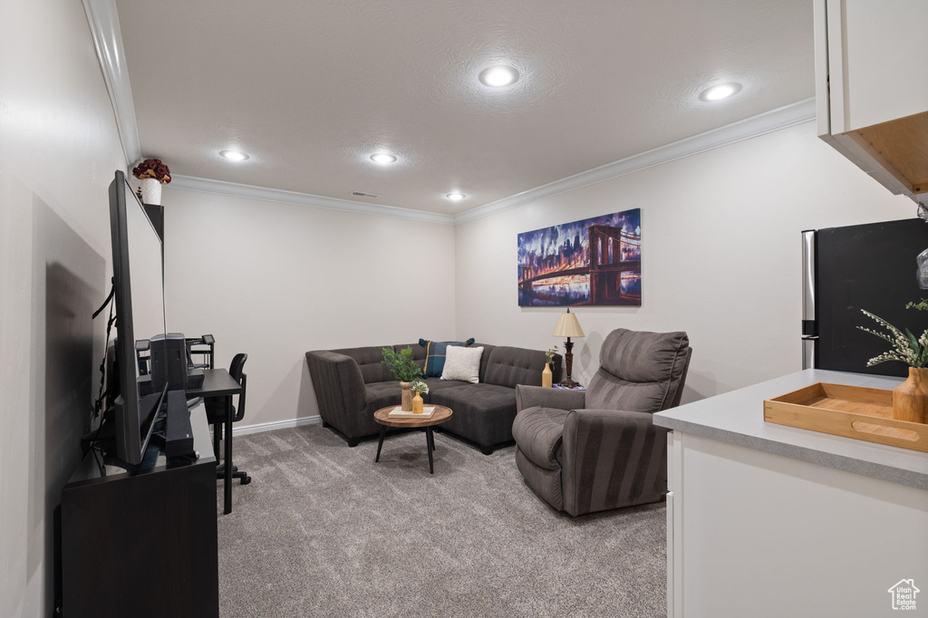 Living room with light colored carpet, recessed lighting, and ornamental molding
