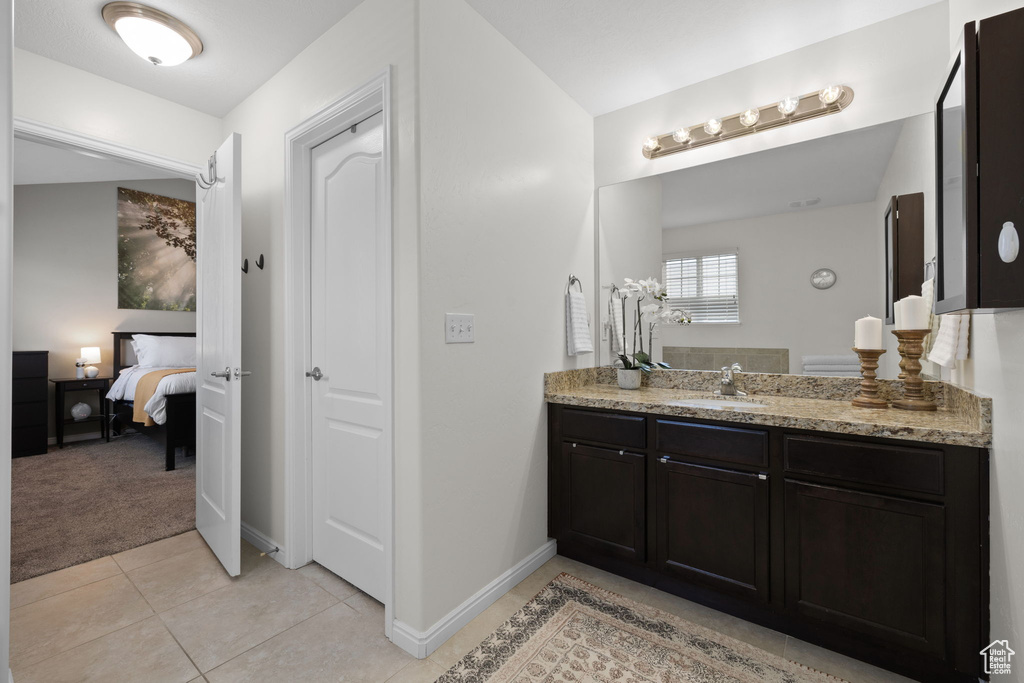 Bathroom with ensuite bath, vanity, and tile patterned floors
