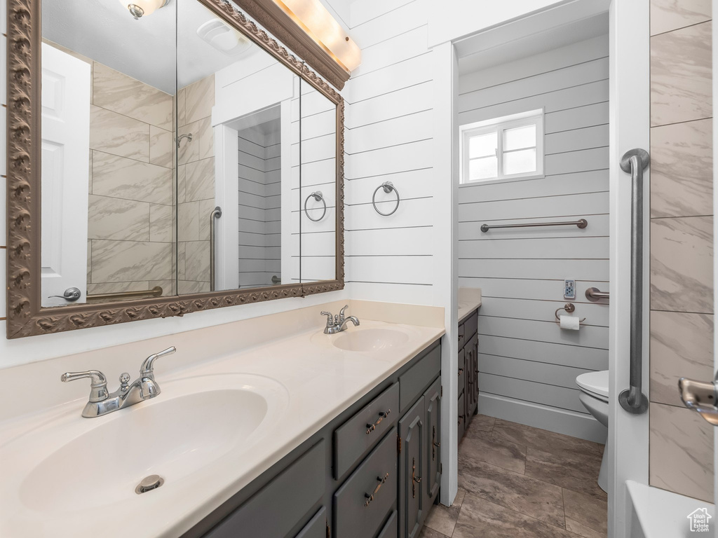 Bathroom featuring double vanity and toilet