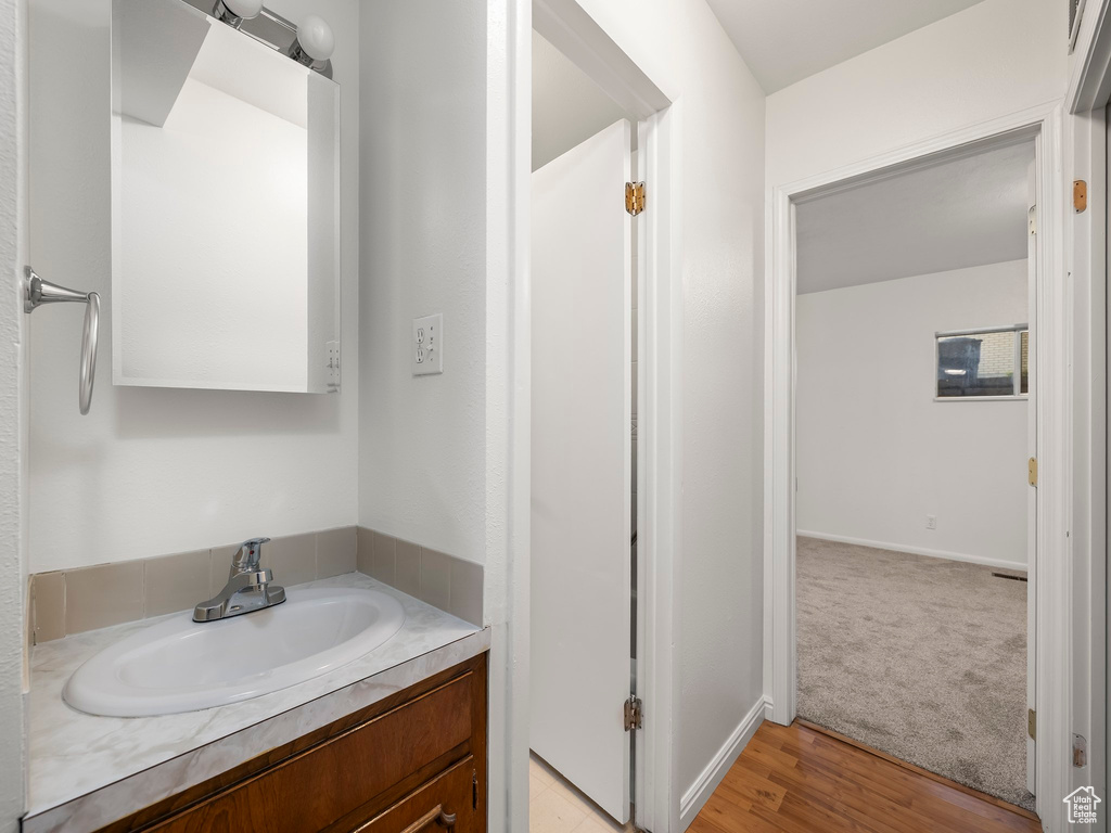 Bathroom featuring vanity and wood finished floors