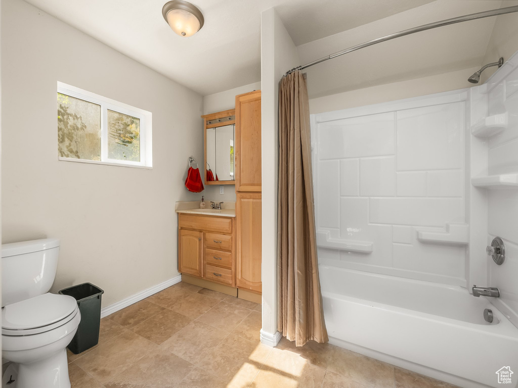 Full bath featuring shower / bath combination with curtain and vanity