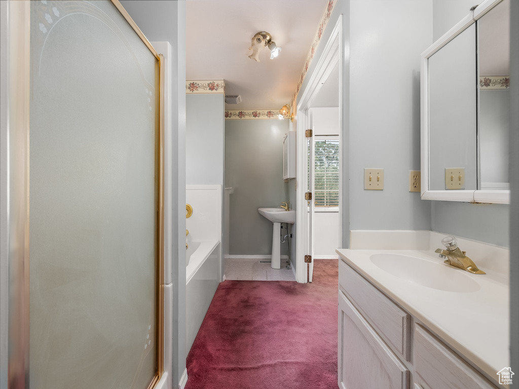Bathroom featuring a bath and a shower stall