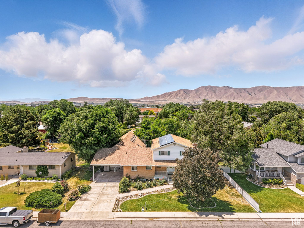 Aerial view of property and surrounding area featuring mountains