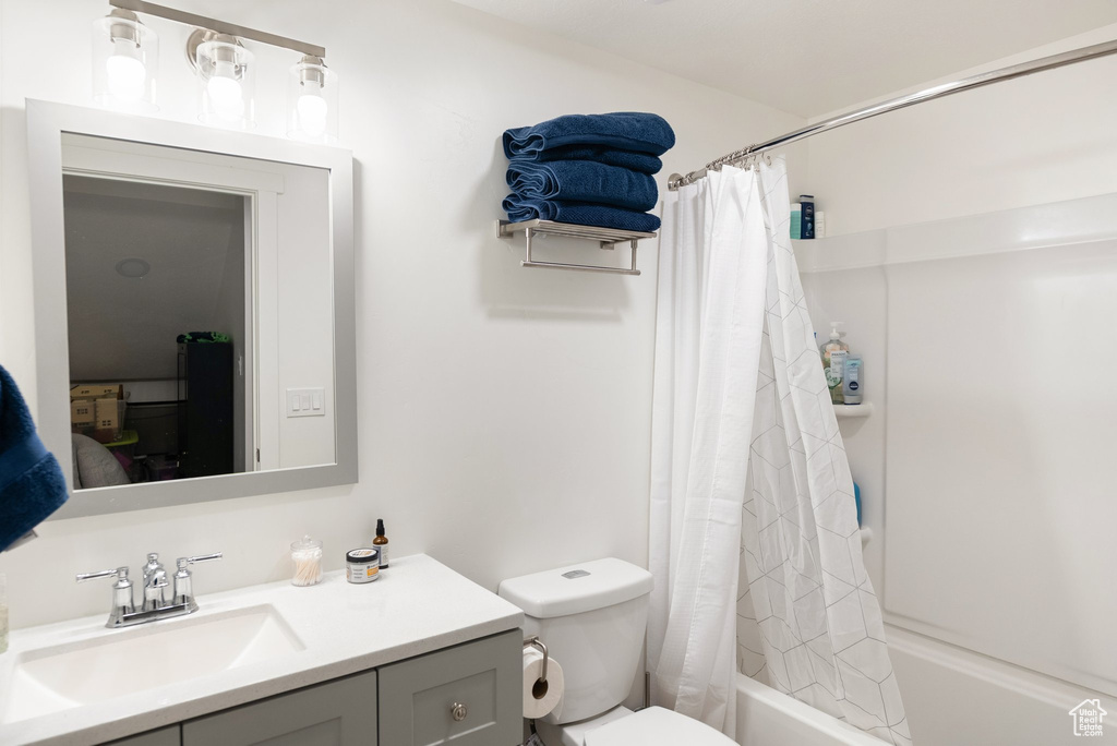 Full bathroom with shower / bathtub combination with curtain and vanity