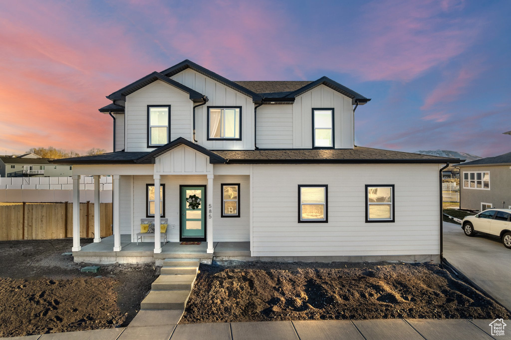 Modern inspired farmhouse with a porch and board and batten siding