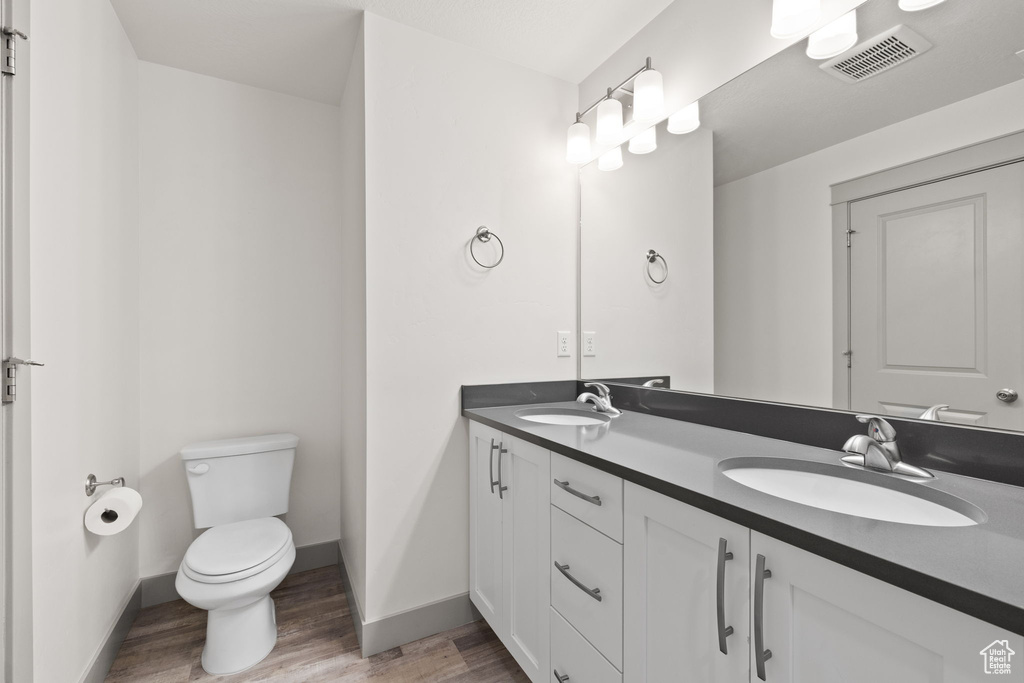 Bathroom with wood finished floors and double vanity