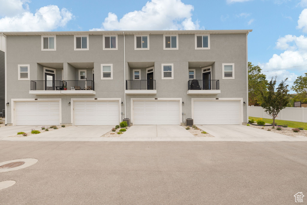 View of property with stucco siding and an attached garage