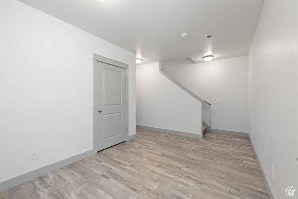 Below grade area with wood finished floors and stairway