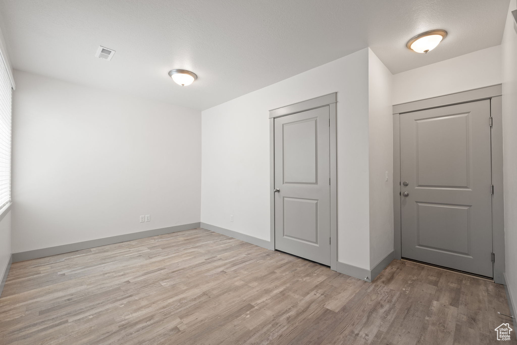 Spare room featuring light wood-type flooring