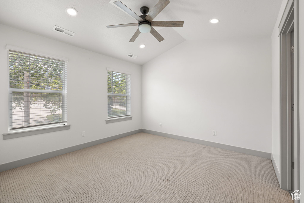 Unfurnished room with light carpet, ceiling fan, recessed lighting, and lofted ceiling