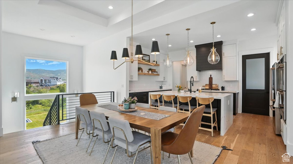 Dining space with recessed lighting and light wood-style floors