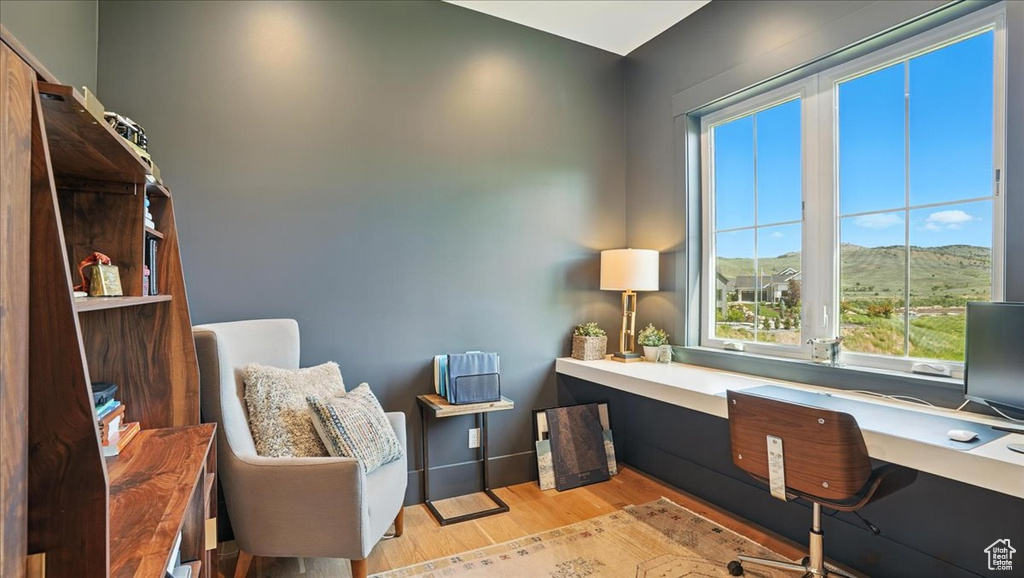 Home office with wood finished floors and baseboards