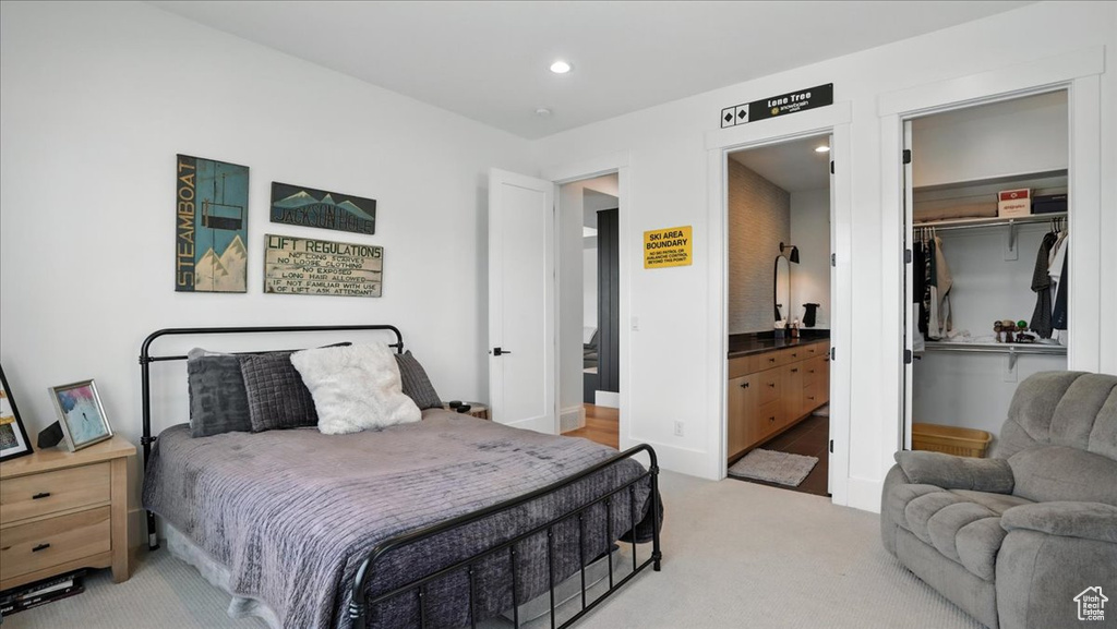 Carpeted bedroom with recessed lighting, connected bathroom, a closet, and a spacious closet