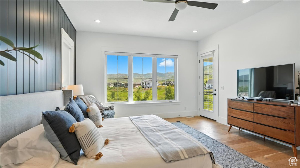 Bedroom featuring access to exterior, wood finished floors, multiple windows, recessed lighting, and ceiling fan