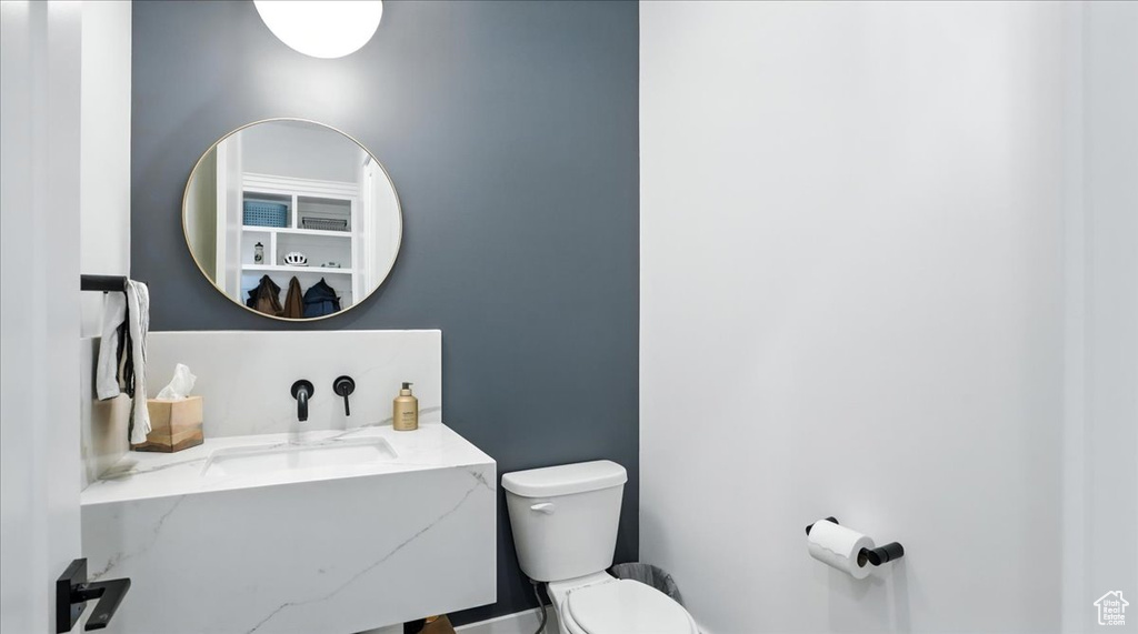 Half bathroom with toilet and vanity